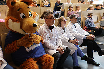 Menschen sitzen im Hörsaal 